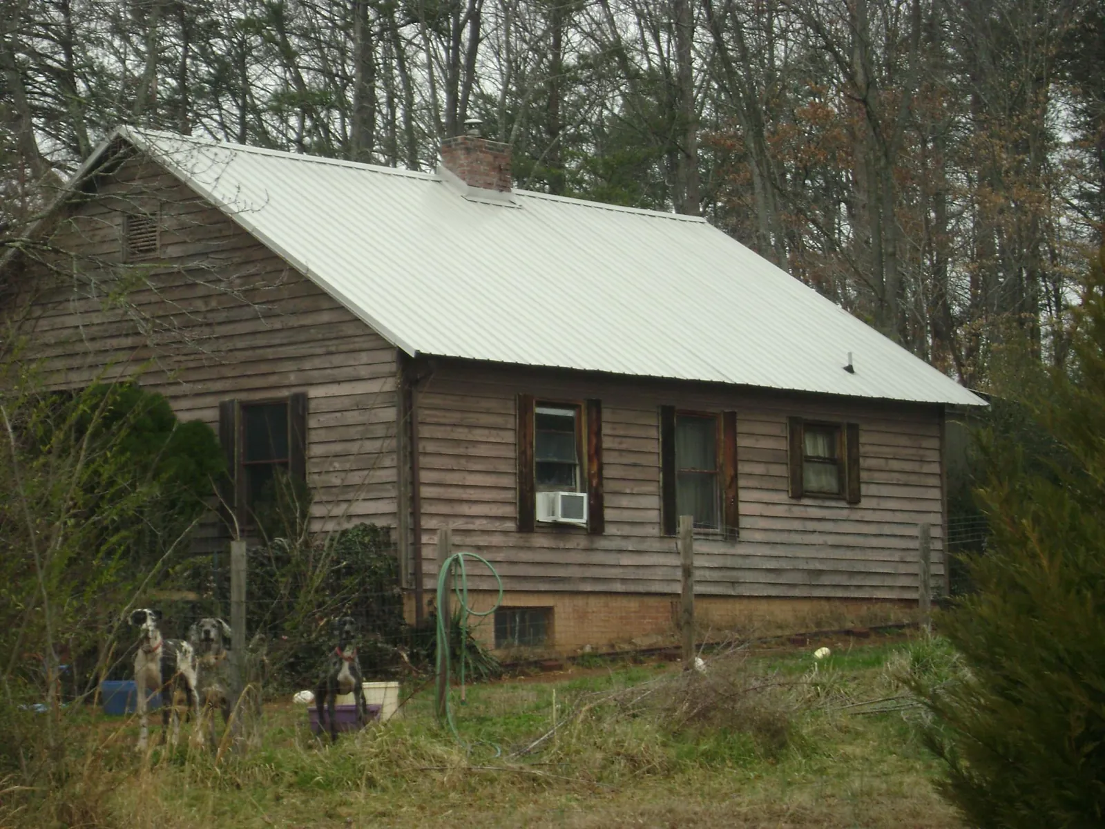 White metal roof on an old wood sided farmhouse, from a Metal Roof Installation job in Etna